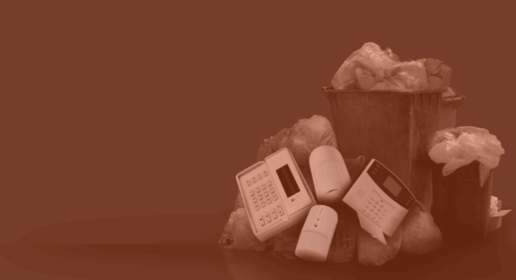security alarm systems piled up in a bin with an orange glow overlayed.